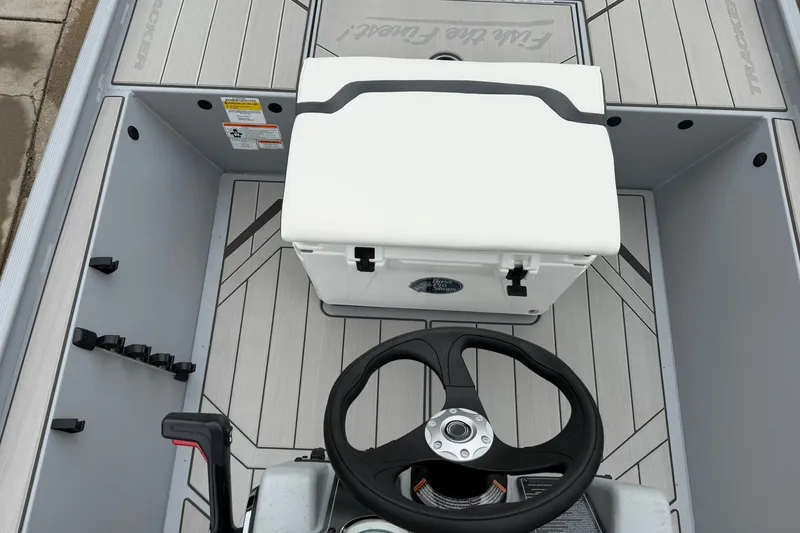 Slide: The Image of 2027 Tracker Bass Tracker Classic CC boat interior with steering wheel and storage compartment. - 20
