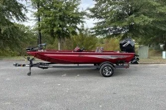 The Image of 2026 Ranger RT178 boat in red, parked on a trailer, surrounded by trees. - 0