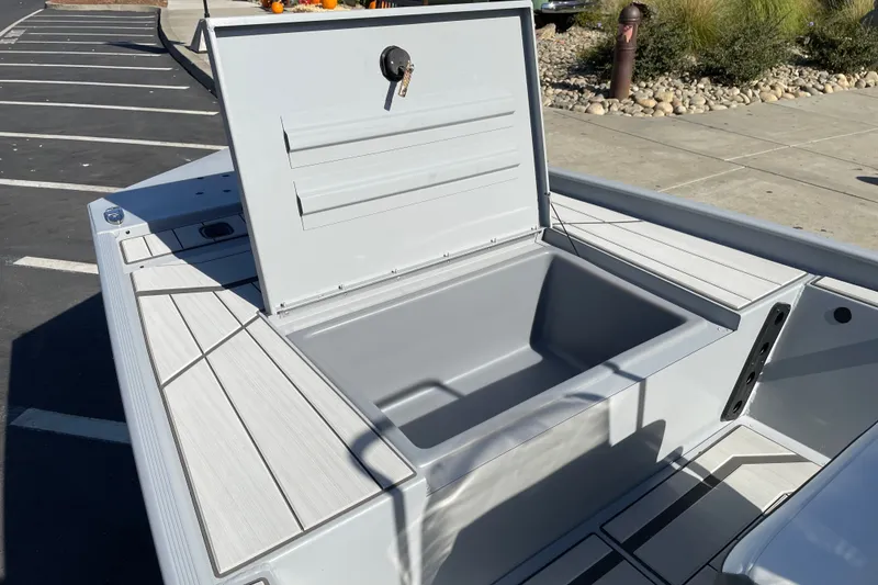Slide: The Image of Open storage compartment on 2027 Tracker Bass Tracker Classic CC boat in parking lot. - 15