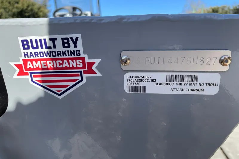 Slide: The Image of 2027 Tracker Bass Tracker Classic CC with "Built by Hardworking Americans" sticker and serial number plate. - 66