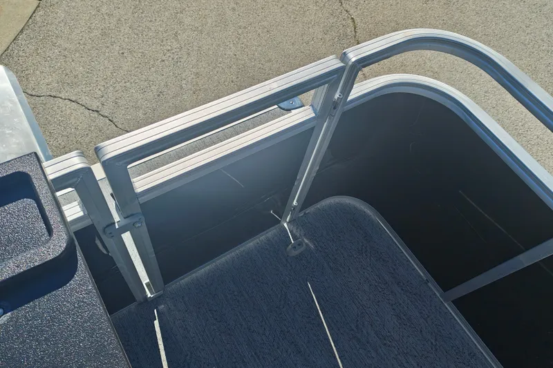 Slide: The Image of 2027 Sun Tracker Fishin' Barge 20 DLX deck with aluminum railing and carpeted floor. - 42