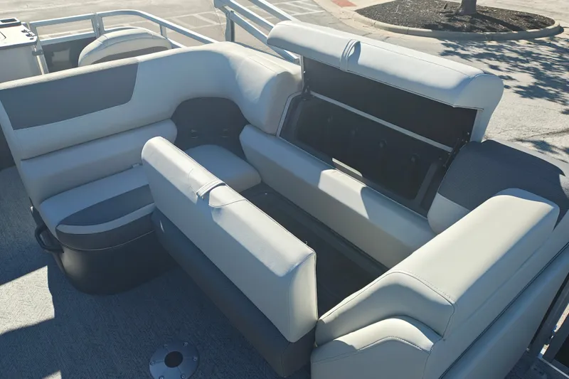 Slide: The Image of 2027 Sun Tracker Fishin' Barge 20 DLX interior seating with storage compartment open. - 23
