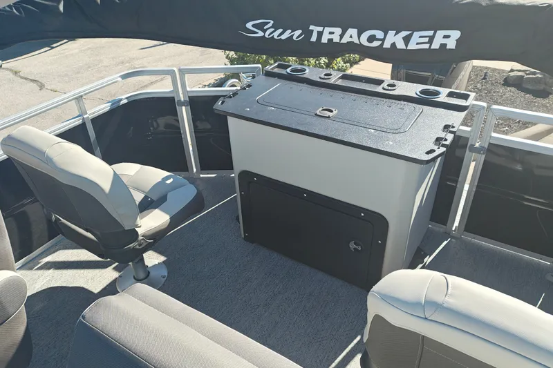Slide: The Image of 2027 Sun Tracker Fishin' Barge 20 DLX interior with seating and storage unit. - 39