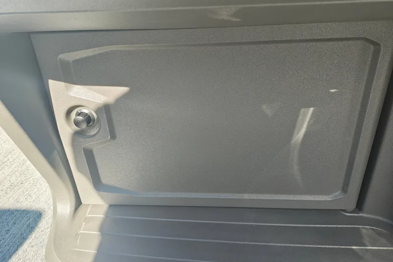 Slide: The Image of 2027 Sun Tracker Fishin' Barge 20 DLX storage compartment with secure latch. - 35