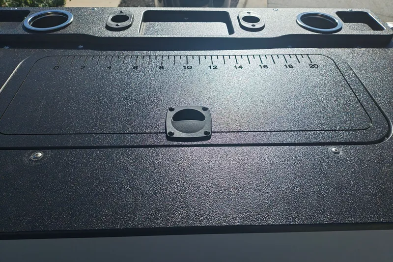 Slide: The Image of 2027 Sun Tracker Fishin' Barge 20 DLX deck with measurement markings and cup holders. - 40