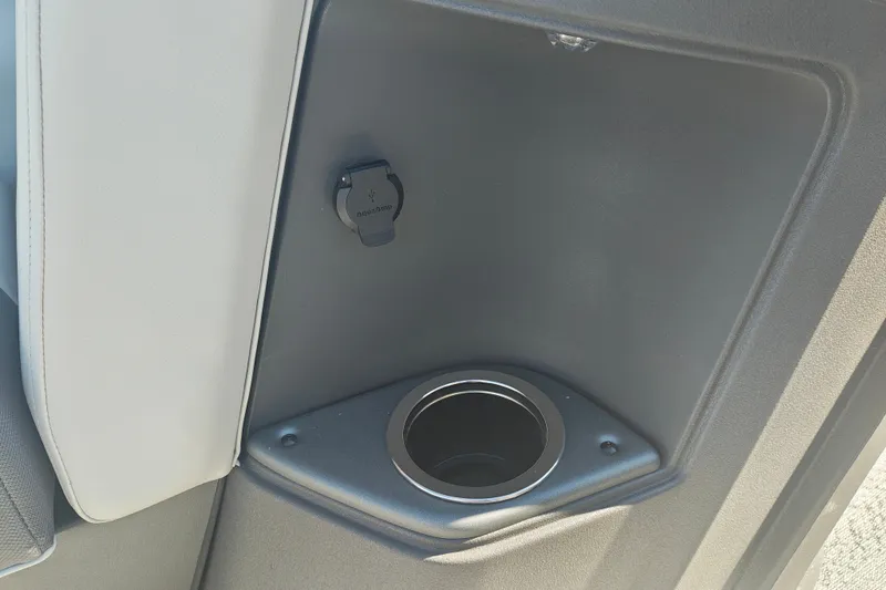 Slide: The Image of 2027 Sun Tracker Fishin' Barge 20 DLX cup holder and USB port detail. - 19