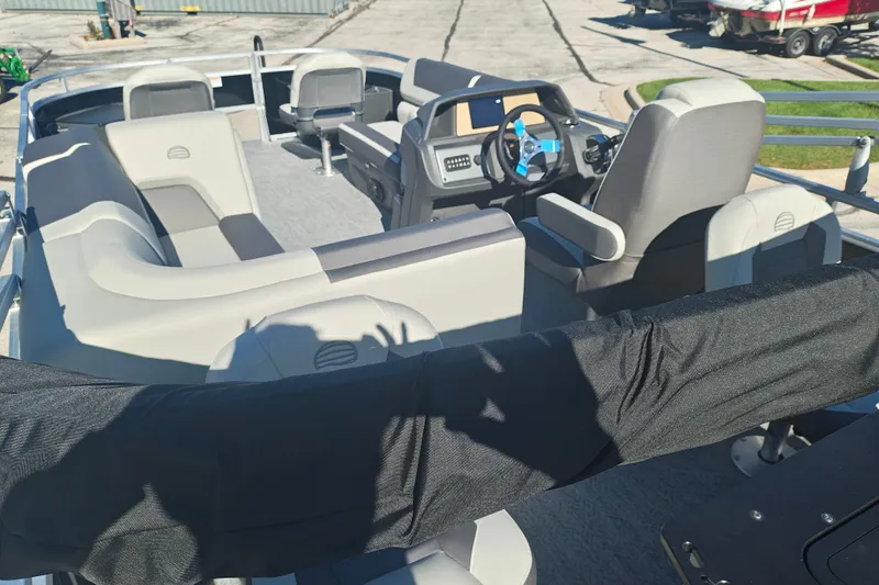 Slide: The Image of 2027 Sun Tracker Fishin' Barge 20 DLX interior with seating and steering console. - 50