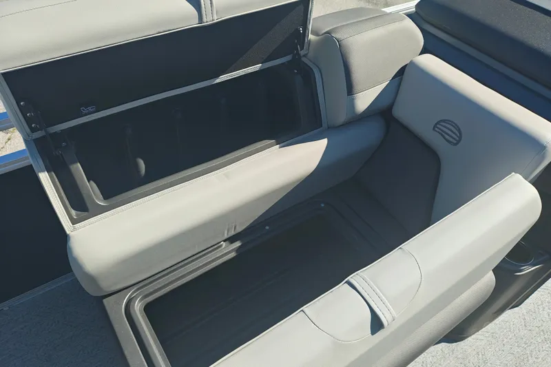 Slide: The Image of 2027 Sun Tracker Fishin' Barge 20 DLX boat seat storage compartment open. - 17