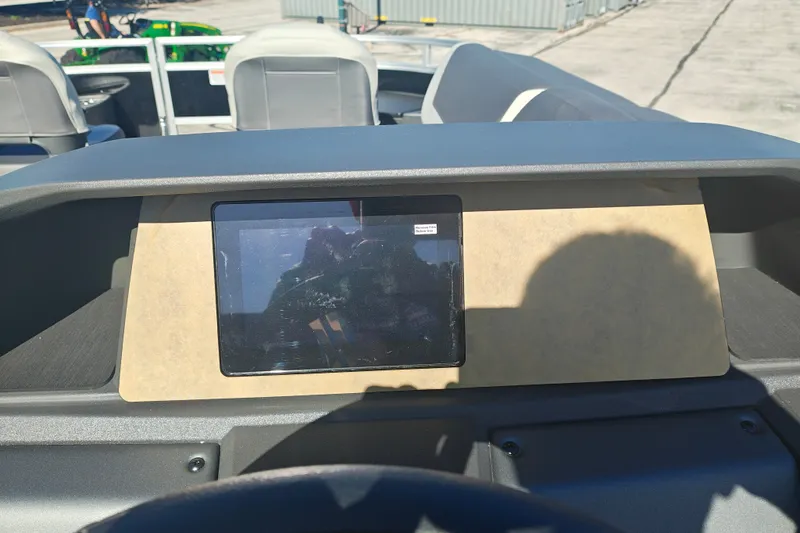 Slide: The Image of Dashboard of a 2027 Sun Tracker Fishin' Barge 20 DLX pontoon boat in sunlight. - 30