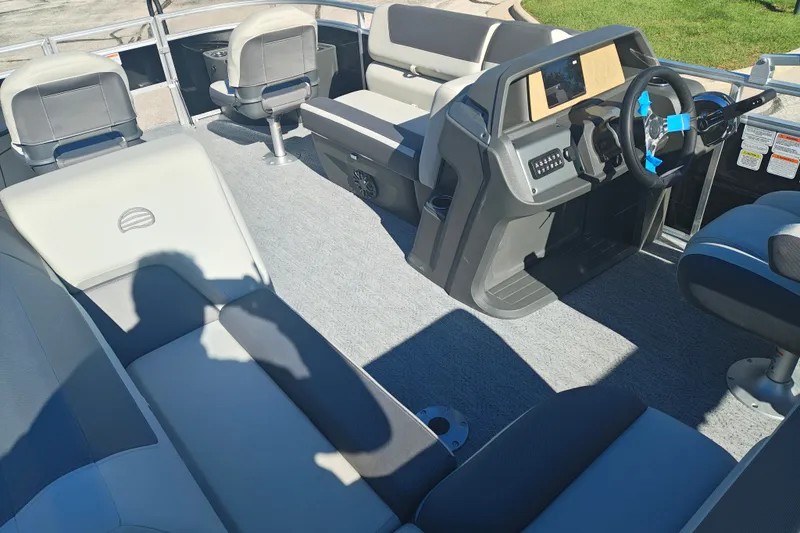Slide: The Image of Interior of 2027 Sun Tracker Fishin' Barge 20 DLX, featuring seating and steering console. - 54