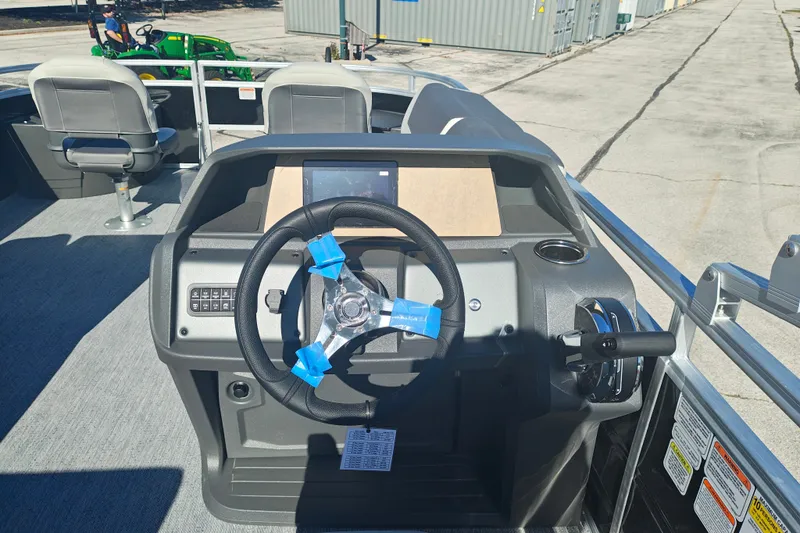 Slide: The Image of 2027 Sun Tracker Fishin' Barge 20 DLX steering console with modern controls and seating. - 28