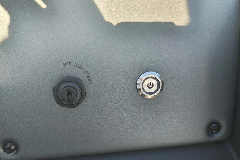 Slide: The Image of Control panel of 2027 Sun Tracker Fishin' Barge 20 DLX with ignition and power button. - 31