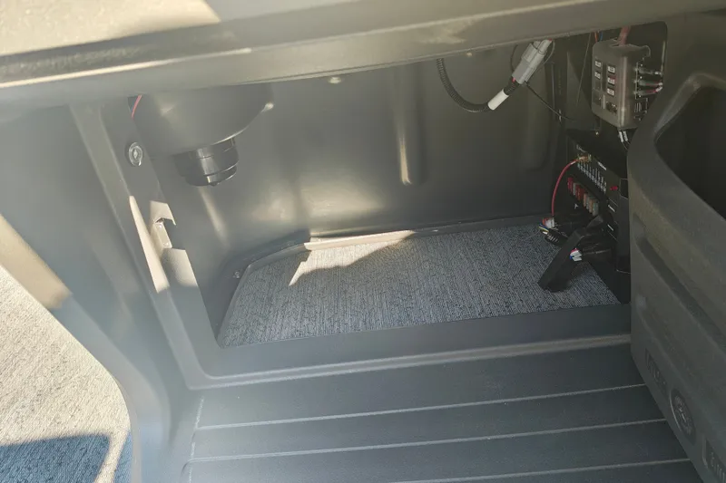 Slide: The Image of Interior view of 2027 Sun Tracker Fishin' Barge 20 DLX storage compartment with wiring. - 36