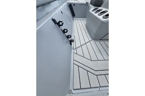 Slide: The Image of 2027 Tracker Bass Tracker 175 CC boat interior with rod holders and sleek flooring design. - 13