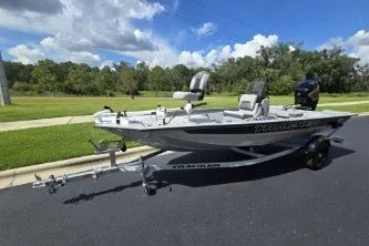 The Image of 2027 Tracker Bass Tracker 175 CC boat on trailer, parked on a sunny day. - 0