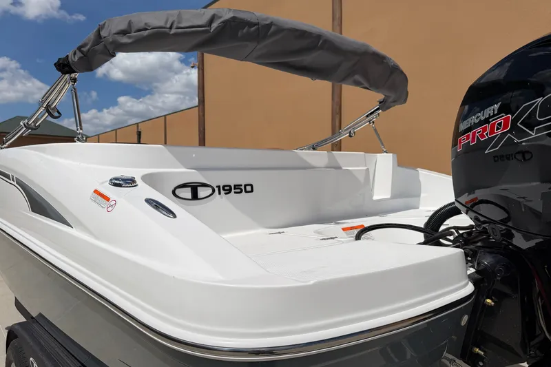 Slide: The Image of 2027 Tahoe 1950 boat with Mercury Pro XS engine, docked under a clear sky. - 6