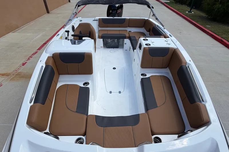 Slide: The Image of Modern 2027 Tahoe 1950 boat interior with brown and black seating, docked on concrete. - 8