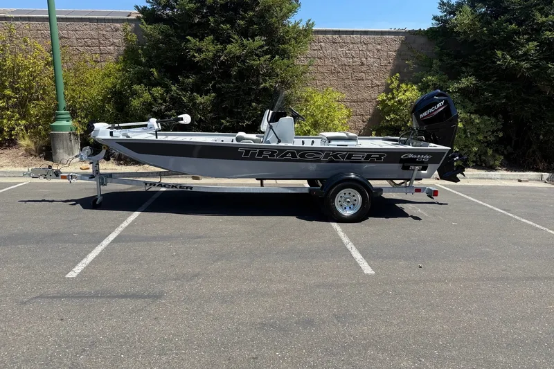 The Image of 2027 Tracker Bass Tracker Classic CC boat on trailer in parking lot. - 0