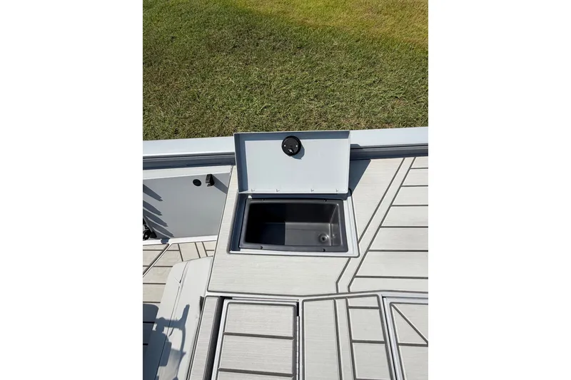 Slide: The Image of 2027 Tracker Bass Tracker 175 CC boat deck with open storage compartment. - 53