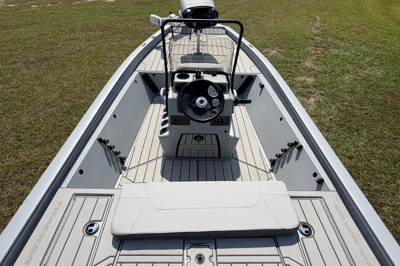 Slide: The Image of 2027 Tracker Bass Tracker 175 CC boat interior with steering console on grassy area. - 41