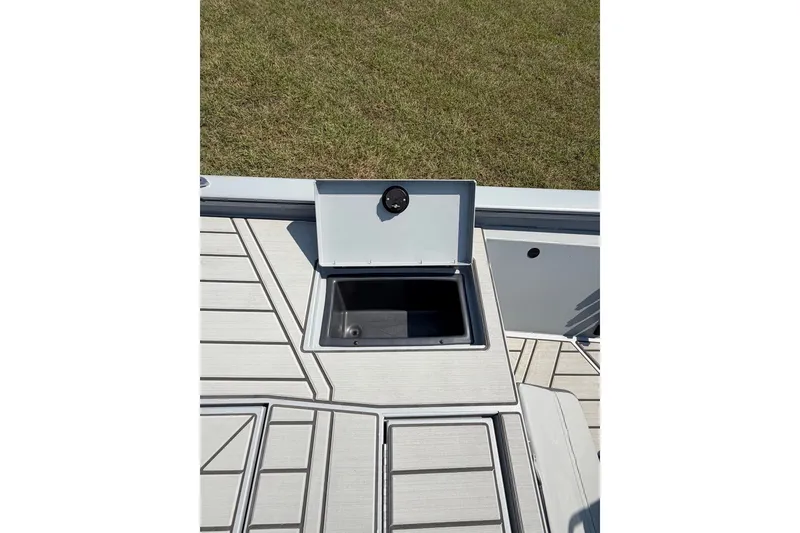 Slide: The Image of 2027 Tracker Bass Tracker 175 CC boat deck with open storage compartment. - 52