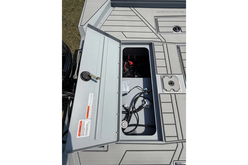 Slide: The Image of 2027 Tracker Bass Tracker 175 CC boat storage compartment with open lid and visible wiring. - 54