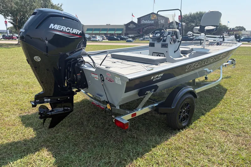 Slide: The Image of 2027 Tracker Bass Tracker 175 CC boat with Mercury engine on grassy field. - 38