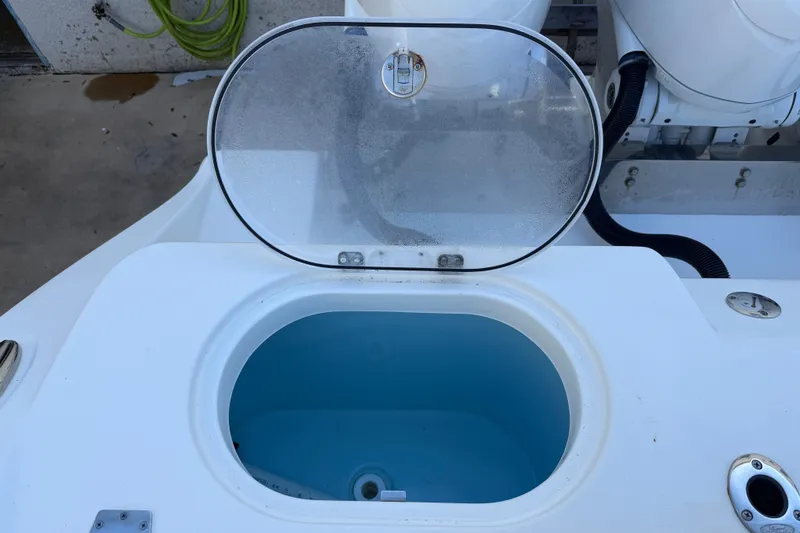 Slide: The Image of Open hatch on 2024 Cobia 350 Center Console boat, revealing storage compartment. - 15