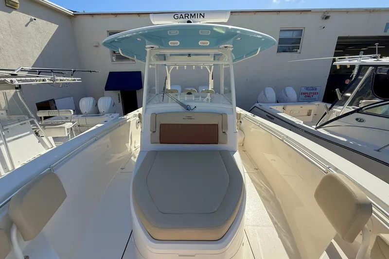 Slide: The Image of 2024 Cobia 350 Center Console boat with Garmin equipment, docked in a marina. - 34