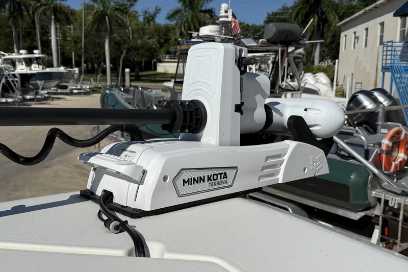 Slide: The Image of Minn Kota Terrova motor on 2024 Cobia 350 Center Console boat, docked with palm trees. - 37