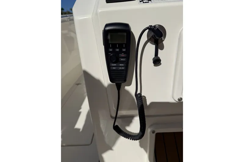 Slide: The Image of VHF radio handset on 2024 Cobia 350 Center Console boat dashboard. - 30