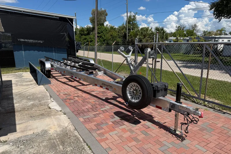 Slide: The Image of Trailer for 2024 Cobia 350 Center Console on brick driveway, sunny day. - 49