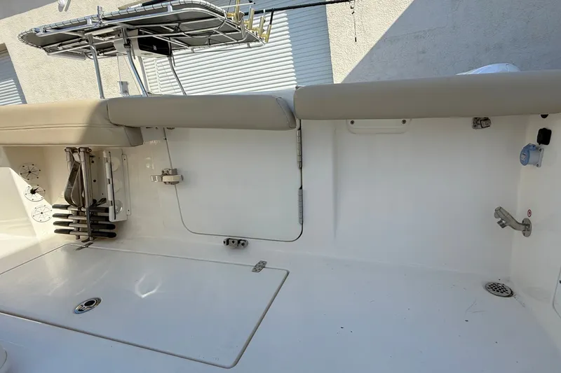 Slide: The Image of 2024 Cobia 350 Center Console boat interior with seating and fishing rod holders. - 44