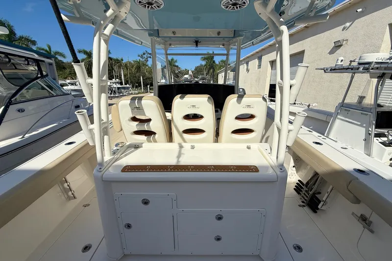 Slide: The Image of 2024 Cobia 350 Center Console boat interior with seating and fishing rod holders. - 17