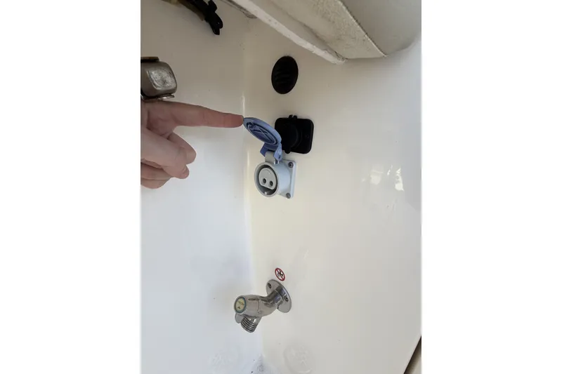 Slide: The Image of 2024 Cobia 350 Center Console boat showing utility connections and fittings. - 45
