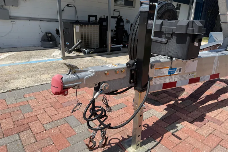 Slide: The Image of Trailer hitch of a 2024 Cobia 350 Center Console boat on a brick driveway. - 53