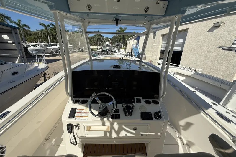 Slide: The Image of 2024 Cobia 350 Center Console boat interior with steering wheel and control panel. - 23