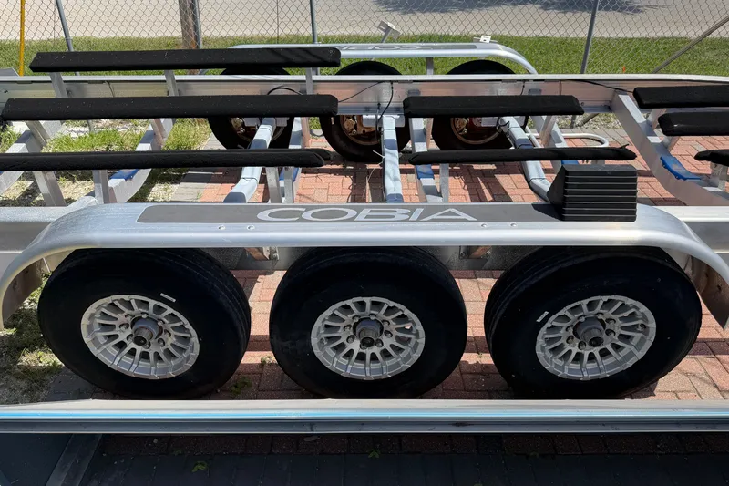 Slide: The Image of Trailer for 2024 Cobia 350 Center Console boat with triple axle wheels. - 55
