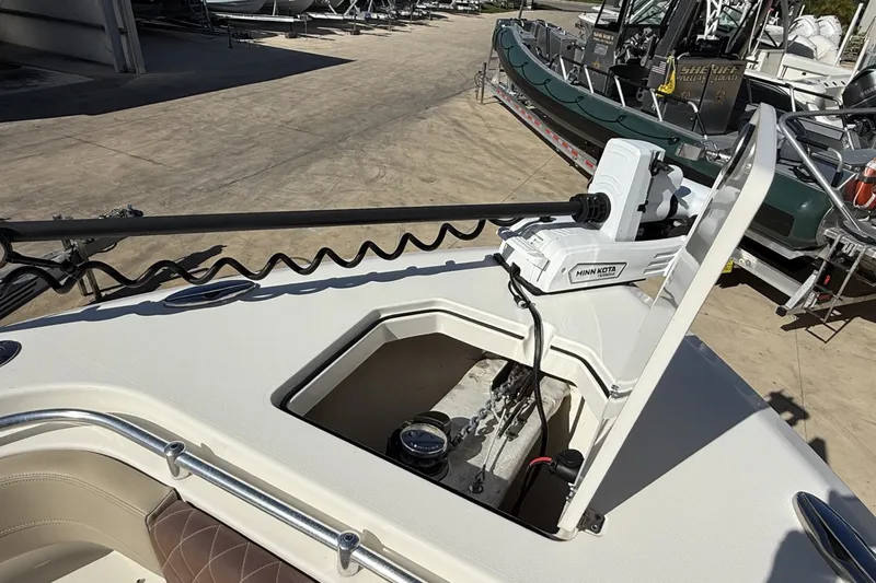 Slide: The Image of 2024 Cobia 350 Center Console boat with Minn Kota trolling motor on deck. - 38
