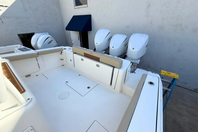 Slide: The Image of 2024 Cobia 350 Center Console boat with triple Yamaha outboard engines. - 13