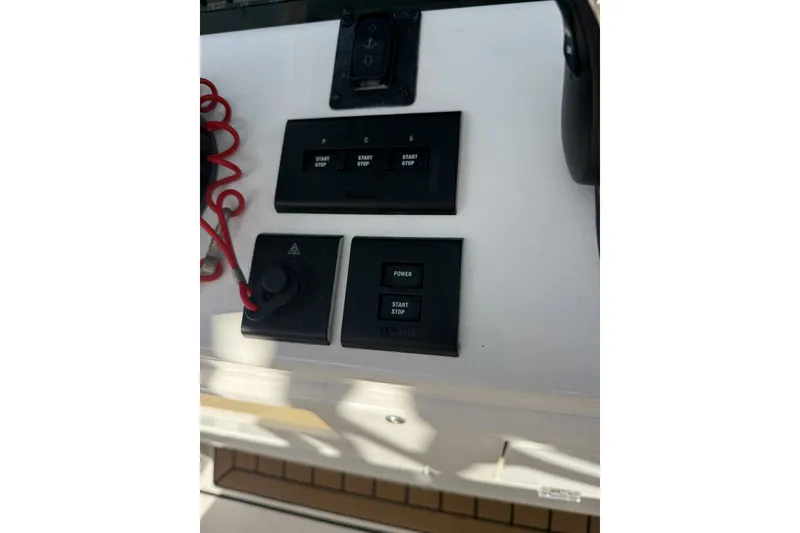 Slide: The Image of Control panel of 2024 Cobia 350 Center Console boat with start-stop buttons. - 29