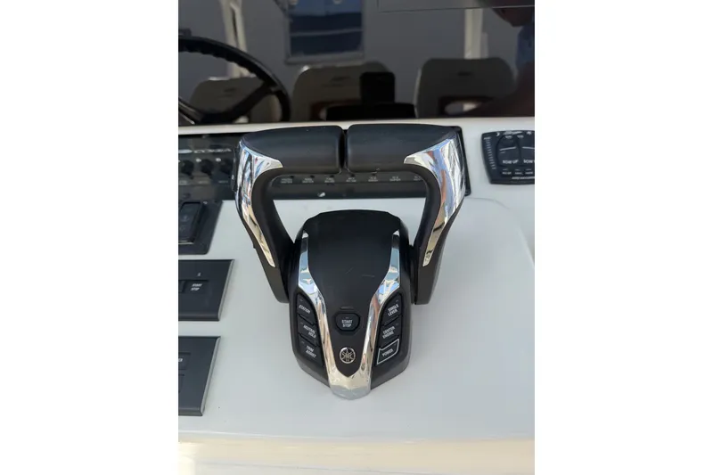 Slide: The Image of Throttle controls on a 2024 Cobia 350 Center Console boat dashboard. - 26