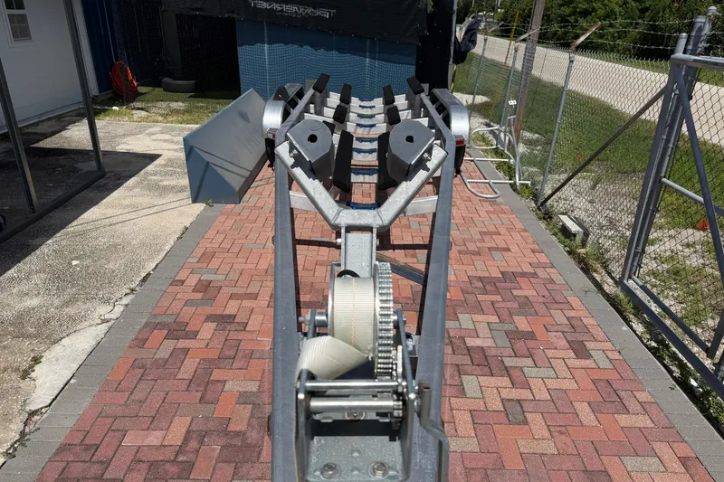 Slide: The Image of Boat trailer for 2024 Cobia 350 Center Console on brick driveway. - 51