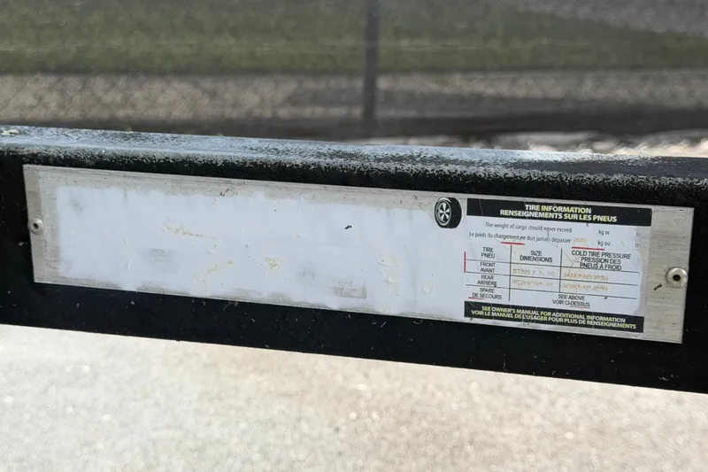 Slide: The Image of Tire information label on a 2023 Wellcraft 202 Fisherman boat trailer. - 57