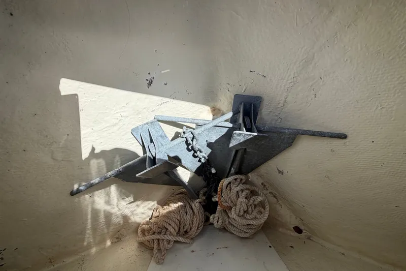 Slide: The Image of An anchor with chain and ropes is placed in the bow of a boat. - 34