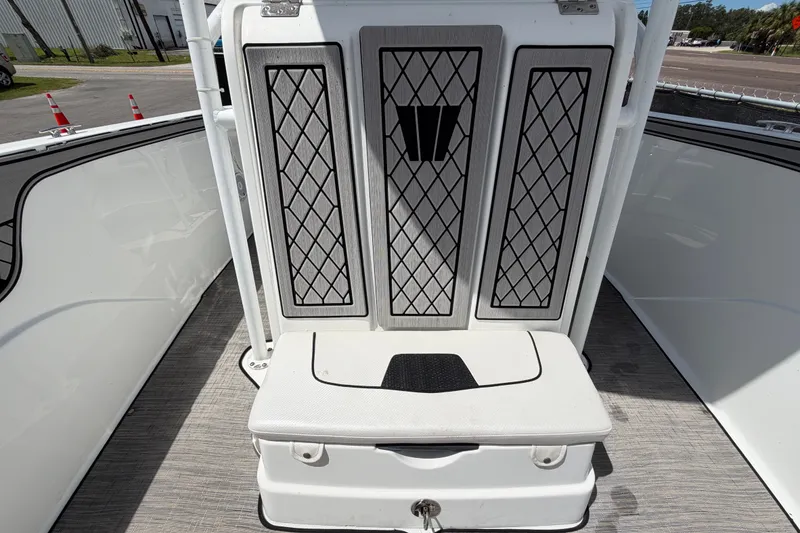 Slide: The Image of 2023 Wellcraft 202 Fisherman boat interior with cushioned seating and storage compartment. - 39
