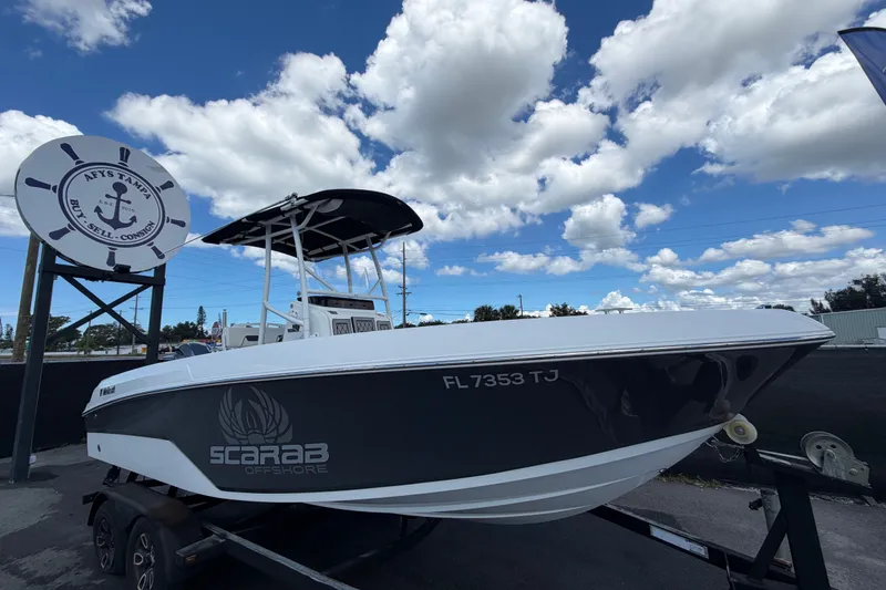 The Image of 2023 Wellcraft 202 Fisherman boat on trailer under cloudy sky. - 0