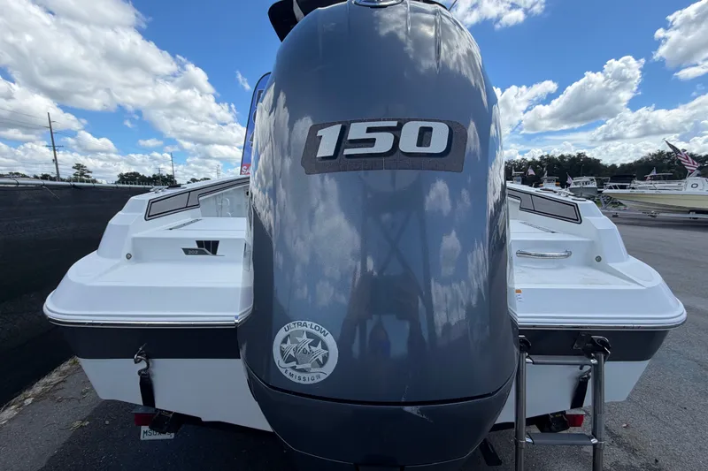 Slide: The Image of 2023 Wellcraft 202 Fisherman boat with 150 horsepower engine, parked outdoors. - 3