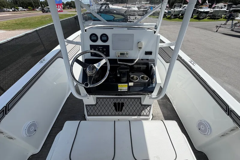 Slide: The Image of 2023 Wellcraft 202 Fisherman boat cockpit with steering wheel and control panel. - 13