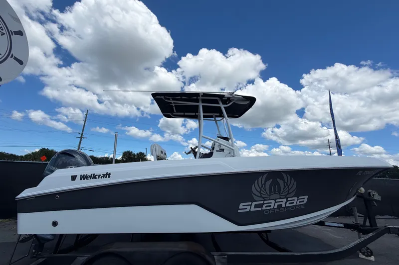 Slide: The Image of 2023 Wellcraft 202 Fisherman boat on trailer under blue sky with clouds. - 1